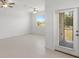 Bright living area with two ceiling fans, large windows, and patio doors at 7018 Ripple Pond Loop, Zephyrhills, FL 33541