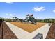 Community playground surrounded by green trees with multiple play structures and a wood chip safety base at 7018 Ripple Pond Loop, Zephyrhills, FL 33541