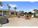 Community pool area with palm trees, lounge seating, outdoor grill and clubhouse nearby at 7018 Ripple Pond Loop, Zephyrhills, FL 33541