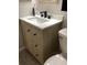 This is a vanity with a wood cabinet and drawers with a solid white countertop and black hardware at 7321 Isle Dr, Port Richey, FL 34668