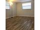 Bedroom featuring wood-look flooring, bright windows, and neutral walls at 7321 Isle Dr, Port Richey, FL 34668