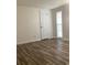 Bedroom features wood-look flooring, window, and neutral decor at 7321 Isle Dr, Port Richey, FL 34668