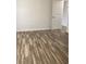 Bedroom featuring wood-look floors, neutral walls, and bright natural light at 7321 Isle Dr, Port Richey, FL 34668