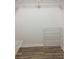 View of an empty closet with shelves and wood-look flooring at 7321 Isle Dr, Port Richey, FL 34668