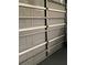 This is a garage door that is partially open, allowing light in at 7321 Isle Dr, Port Richey, FL 34668