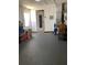 Garage with white walls and concrete floor with a view of a room and backyard through the door at 7321 Isle Dr, Port Richey, FL 34668