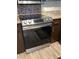 Modern kitchen featuring a stainless steel range oven, sleek cabinetry, and tiled backsplash at 7321 Isle Dr, Port Richey, FL 34668