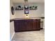 A charming kitchen area with dark wood cabinets, stylish decor, and under-cabinet lighting at 7321 Isle Dr, Port Richey, FL 34668
