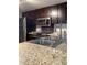 Updated kitchen boasting stainless steel appliances, granite countertops, and mosaic tile backsplash at 7321 Isle Dr, Port Richey, FL 34668