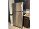Spacious kitchen featuring a stainless steel refrigerator and coordinating dark wood cabinetry at 7321 Isle Dr, Port Richey, FL 34668