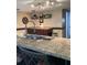 A well-appointed kitchen featuring granite countertops, a stainless steel sink, and modern lighting at 7321 Isle Dr, Port Richey, FL 34668