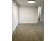 Carpeted room with an opening and a sliding glass door at 7321 Isle Dr, Port Richey, FL 34668