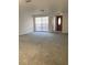 Spacious living room with large window for natural light, and a classic wooden front door at 7321 Isle Dr, Port Richey, FL 34668