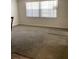 Living room with carpet, bright window, and neutral wall color at 7321 Isle Dr, Port Richey, FL 34668