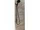 This is a shower head that is mounted on the wall of a shower at 7321 Isle Dr, Port Richey, FL 34668