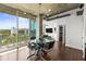 Open-concept living space with a dining table, balcony access, and cityscape views at 777 N Ashley Dr # 402, Tampa, FL 33602