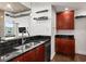 Kitchen boasting dark wood cabinets, black countertops, and a stainless steel sink at 777 N Ashley Dr # 402, Tampa, FL 33602