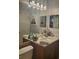 Beautiful bathroom vanity showcases a decorative light fixture and large mirror at 7941 Clarendon Dr, New Port Richey, FL 34654