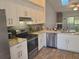 Bright kitchen featuring stainless steel appliances and ample counter space at 7941 Clarendon Dr, New Port Richey, FL 34654
