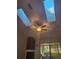 Living room showcases vaulted ceilings, skylights, fireplace, and sliding glass doors at 7941 Clarendon Dr, New Port Richey, FL 34654