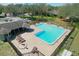 Aerial view of community pool with lounge chairs, and a covered picnic area at 7941 Clarendon Dr, New Port Richey, FL 34654