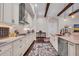 Well-lit kitchen featuring a stainless steel range hood, white cabinetry, and light countertops at 803 Floresta St, Brandon, FL 33511