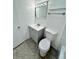 Well-lit bathroom with a vanity, mirror, and toilet at 5604 Larimer Dr, Tampa, FL 33615
