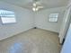 Bright bedroom featuring a ceiling fan and natural light from two windows at 5604 Larimer Dr, Tampa, FL 33615