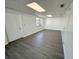 Bright bonus room with fresh paint, new flooring, and sliding glass door at 5604 Larimer Dr, Tampa, FL 33615
