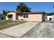 Charming single-story home with a long driveway and quaint curb appeal at 5604 Larimer Dr, Tampa, FL 33615