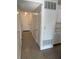 Hallway leading to rooms with speckled floors and white walls at 5604 Larimer Dr, Tampa, FL 33615