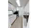 Bright kitchen featuring stainless steel appliances, white cabinetry, and marble countertops at 5604 Larimer Dr, Tampa, FL 33615