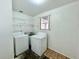 Functional laundry room with washer, dryer hookups, and shelving at 5604 Larimer Dr, Tampa, FL 33615