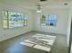 Light-filled living room with neutral paint and tile flooring and large windows at 5604 Larimer Dr, Tampa, FL 33615