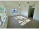 Light-filled living room with neutral paint and tile flooring and large windows at 5604 Larimer Dr, Tampa, FL 33615