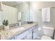 Bathroom with granite countertop, white cabinets, and modern fixtures at 10106 Bessemer Pond Ct, Riverview, FL 33578