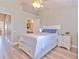 Cozy bedroom offers natural light, wood-look floors, and a modern ceiling fan at 10106 Bessemer Pond Ct, Riverview, FL 33578