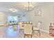 Open-concept dining area with modern lighting and seamless flow to the living room at 10106 Bessemer Pond Ct, Riverview, FL 33578
