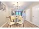 Bright dining area featuring a round glass table and chairs, with views to the kitchen at 10106 Bessemer Pond Ct, Riverview, FL 33578