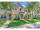 Charming townhome with manicured lawn and inviting entryway with lush green landscaping at 10106 Bessemer Pond Ct, Riverview, FL 33578