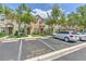 Townhome with tidy front lawns, guest parking, and mature trees providing shade on a sunny day at 10106 Bessemer Pond Ct, Riverview, FL 33578
