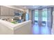 Modern kitchen with stainless steel appliances and granite countertops, adjoining dining area at 10106 Bessemer Pond Ct, Riverview, FL 33578
