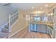 Modern kitchen features gray cabinets, stainless appliances, granite counters, and an adjacent living space at 10106 Bessemer Pond Ct, Riverview, FL 33578