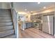 Modern kitchen features gray cabinets, stainless appliances and overlooks an adjacent living and dining space at 10106 Bessemer Pond Ct, Riverview, FL 33578