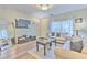 Spacious living room featuring modern furniture, a TV, and natural light at 10106 Bessemer Pond Ct, Riverview, FL 33578