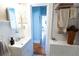Charming bathroom featuring a white vanity, wainscoting, and tiled shower area at 1036 23Rd N Ave, St Petersburg, FL 33704