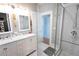 Bright bathroom featuring dual sinks, a glass-enclosed shower, and tasteful finishes at 1036 23Rd N Ave, St Petersburg, FL 33704