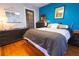 Well-lit bedroom boasting a comfortable bed, modern furnishings, and eye-catching blue accent wall at 1036 23Rd N Ave, St Petersburg, FL 33704