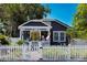 Charming home with a bright yellow door and a white picket fence creating a welcoming curb appeal at 1036 23Rd N Ave, St Petersburg, FL 33704