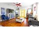 Open living room with hardwood floors, television, and brightly colored accents at 1036 23Rd N Ave, St Petersburg, FL 33704